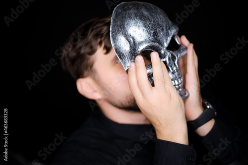 a skeleton mask that a man wants to put on his face