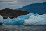 Icebergs floating. Ices and icebergs. Glacier lagoon. Greenland iceberg. Melting ice. South coast Iceland. Jokullsarlon glacier lagoon. Volcanic ash on the ice. Ice age glacier. Melting iceberg.