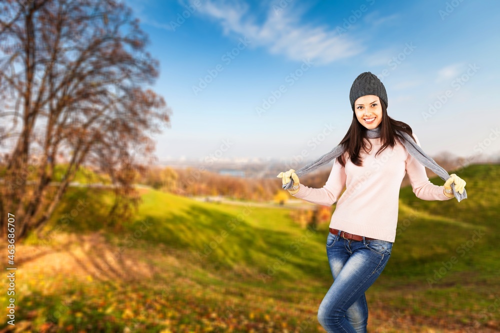 Beautiful young woman enjoying sunny autumn day in nature, walking the forest path Beautiful young woman enjoying sunny autumn day in nature, walking the forest path