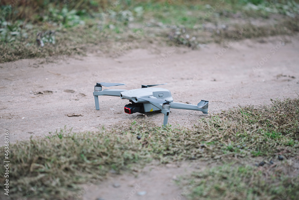 Drone on the ground in the field, modern technology Drone on the ground in the field, modern technology