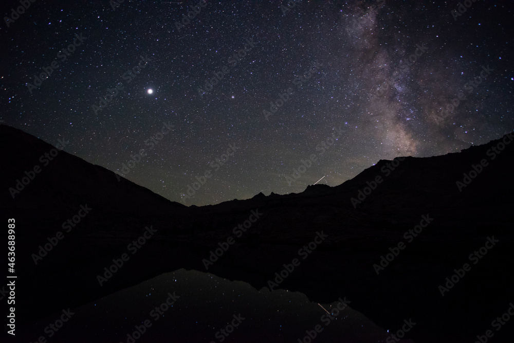 Milky way rising over Vogelsang Peak, reflected in Fletcher Lake, Yosemite National Park Tuolumne Meadows