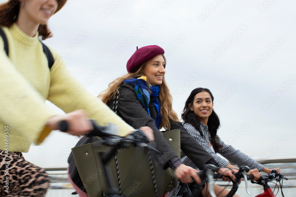 Young women friends riding bicycles Young women friends riding bicycles