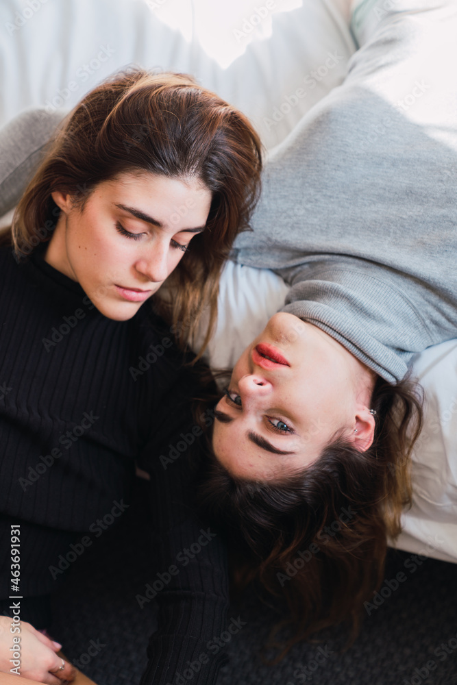 Beautiful twins lying on bed