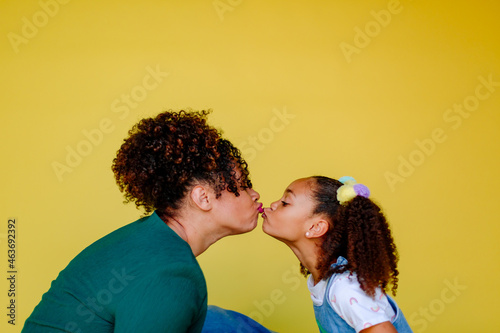 Profile of kiss between mother and daughter