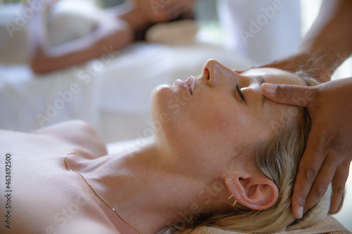 Two Women Getting Head Massages One Woman in Foreground