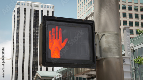 Urban City pedestrian crosswalk safety sign signal with bright orange hand photo