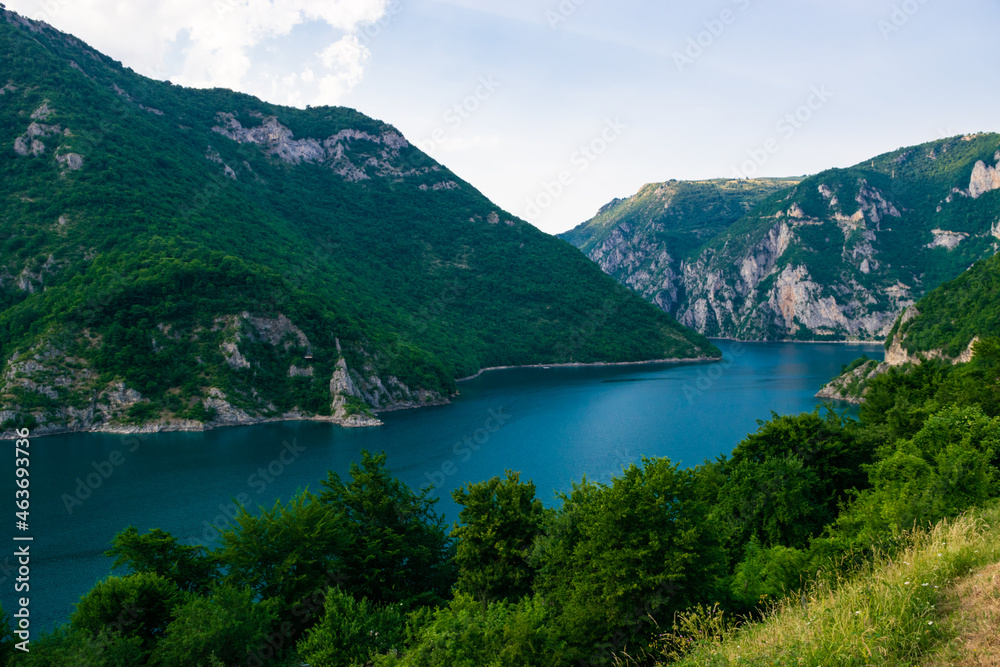 Summer landscape of lake and river Piva between high green mountains near Pluzine. Montenegro.