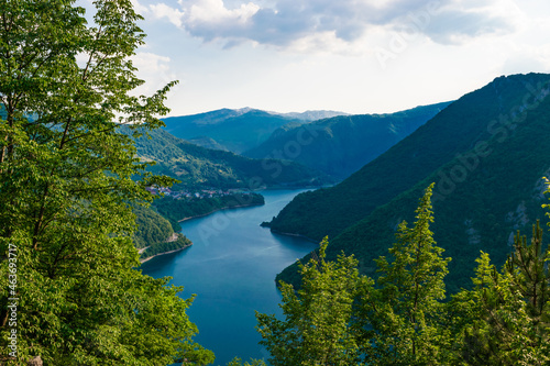 Summer landscape of lake and river Piva between high green mountains near Pluzine. Montenegro.