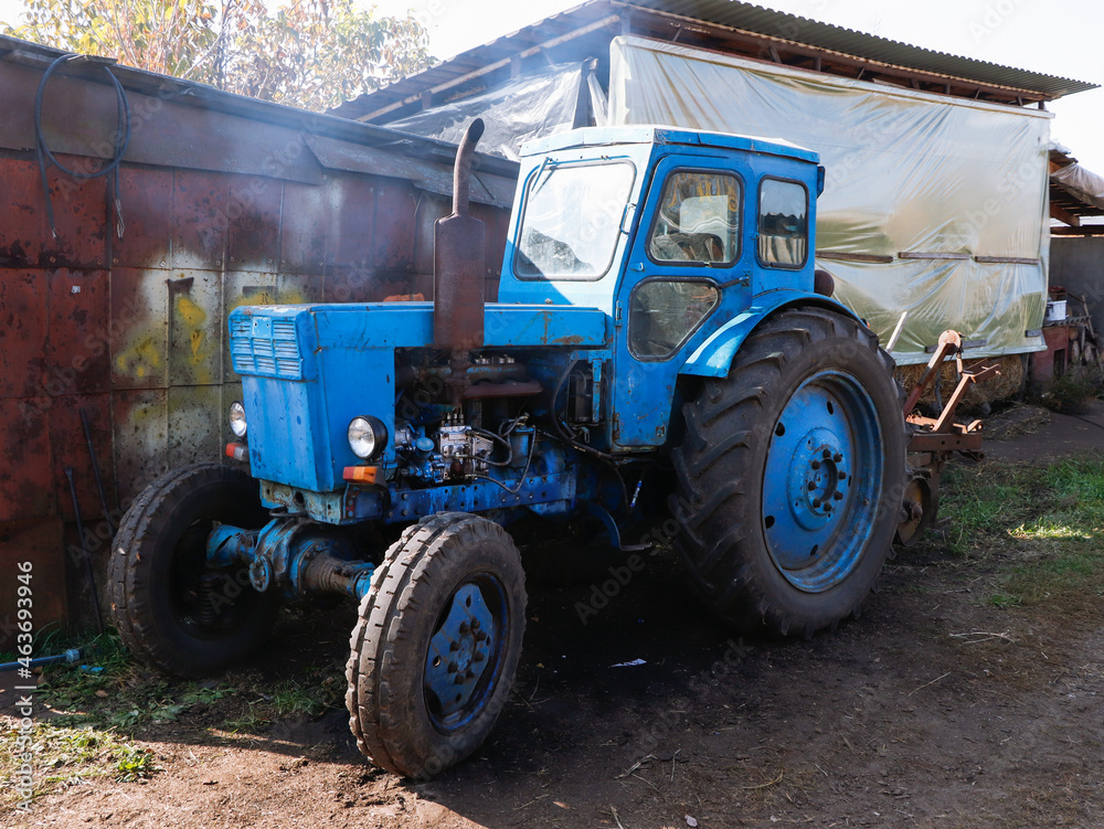 Old soviet tractor exhaust fumes from exhaust pipe at farm. Old soviet tractor exhaust fumes from exhaust pipe at farm.