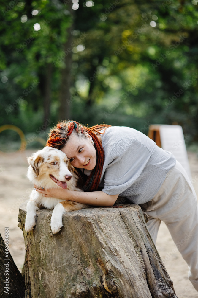 © Oleksii Syrotkin/Stocksy - Girl with dog having fun together