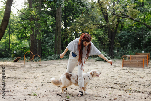 Girl training her dog with treat 