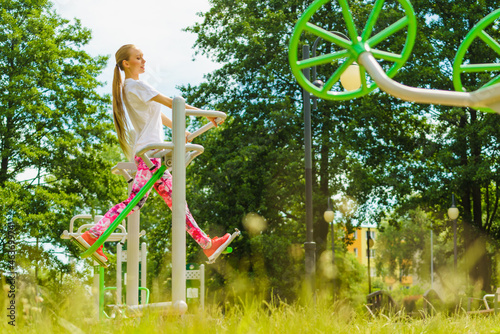 Woman doing exercise in outdoor gym