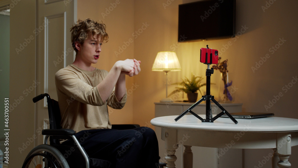 A young disabled man is making hand exercises 