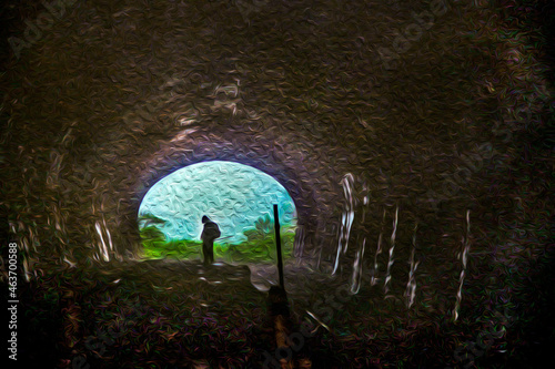 Person at the end of a dark tunnel from an old disused railway line near Paranapiacaba. A small railway village in Brazil. Oil paint filter.