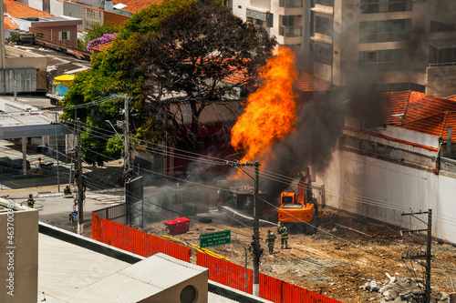 Firefighters fighting a fire caused by a gas leak in a street of São Paulo. The city famous for its cultural and business vocation in Brazil.