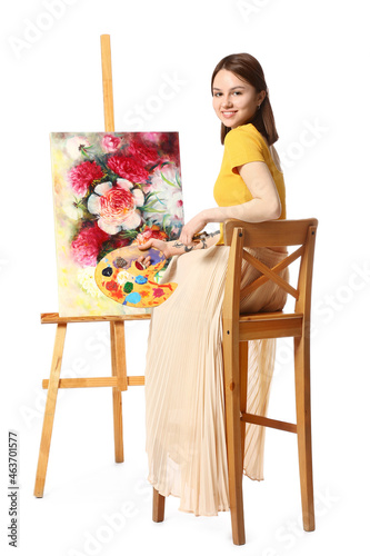 Young female artist paintin...