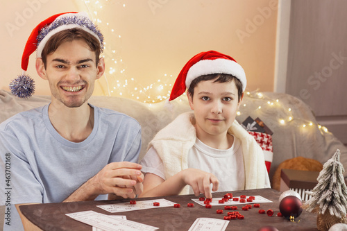 Merry Christmas. Boys wearing Sanata hats for Christmas. Lights. Close-up. 4K photo