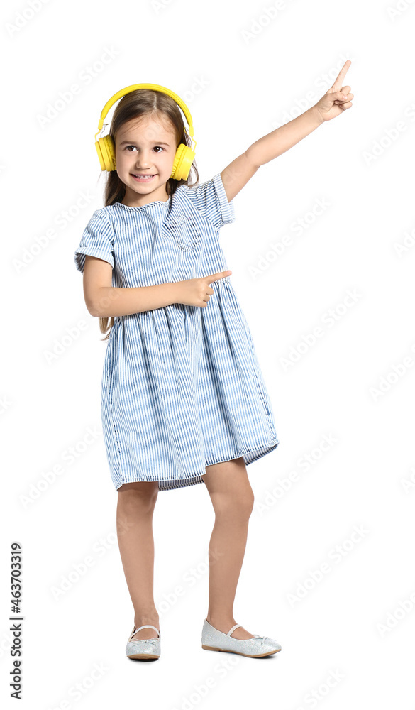 Cute little girl in yellow headphones dancing on white background Cute little girl in yellow headphones dancing on white background
