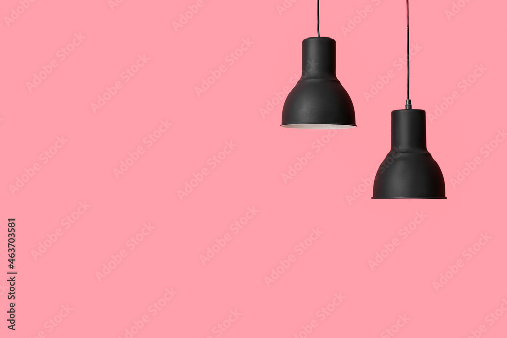 Obraz premium Black lamps hanging on pink background