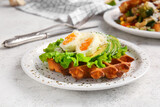 Delicious Belgian waffle with egg, avocado and cheese in plate on light background, closeup