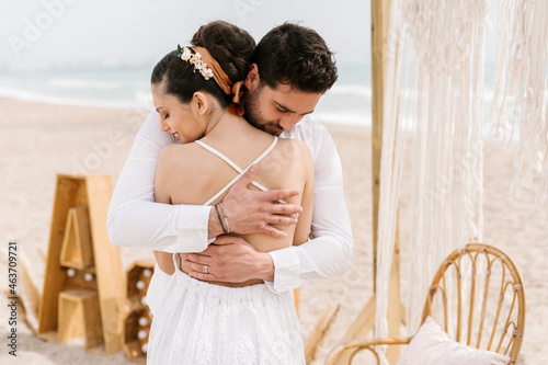 Boyfriend in love lovingly embracing his wife photo