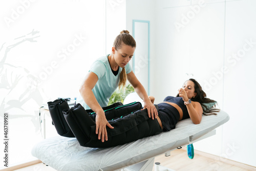 Woman getting pressotherapy in salon photo