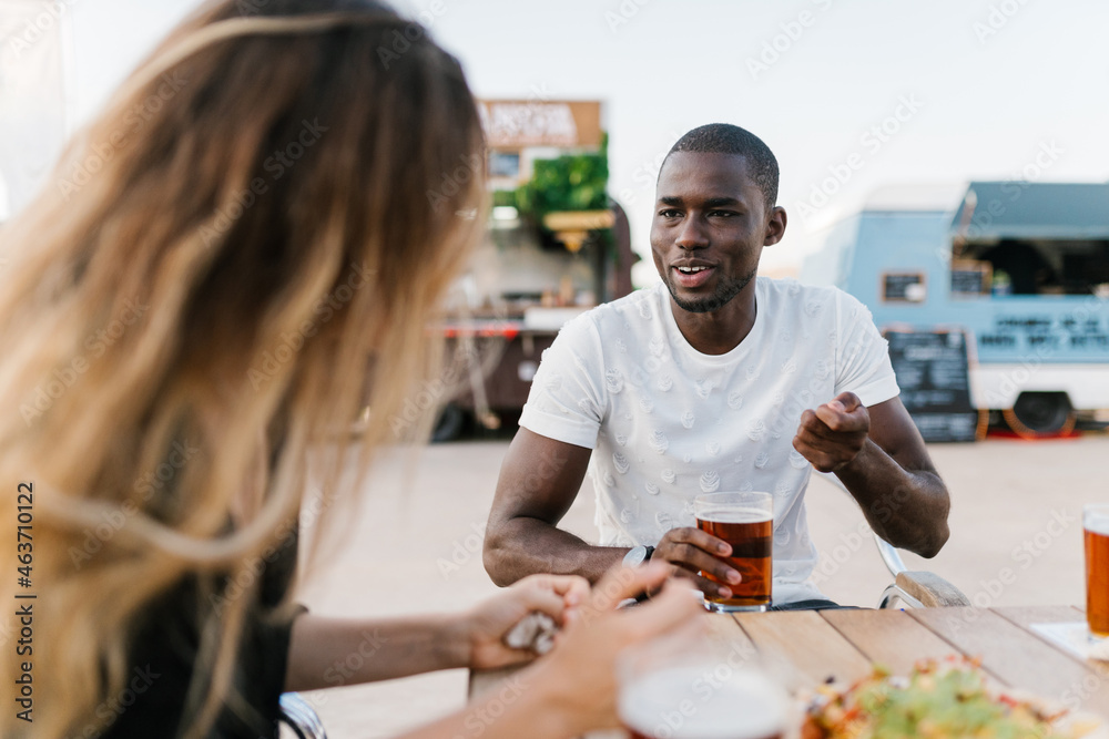 African man talking to his friend at the bar African man talking to his friend at the bar