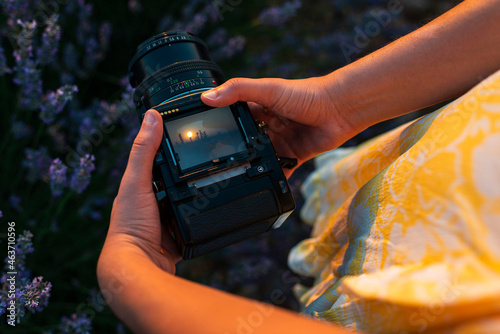 Woman photographer holding analog camera 