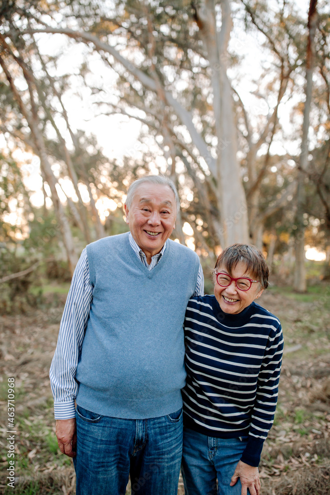 Laughing older Asian couple outdoors Laughing older Asian couple outdoors