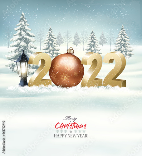 Merry Christmas and Happy New Year 2022. 3D numbers with a gold bauble, light bulb on a winter landscape background. Vector