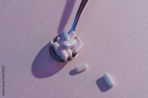Assorted pharmaceutical medicine pills and tablets spoon