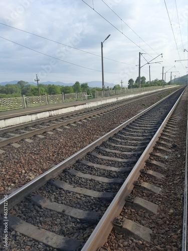 railway track, rails in the distance, road