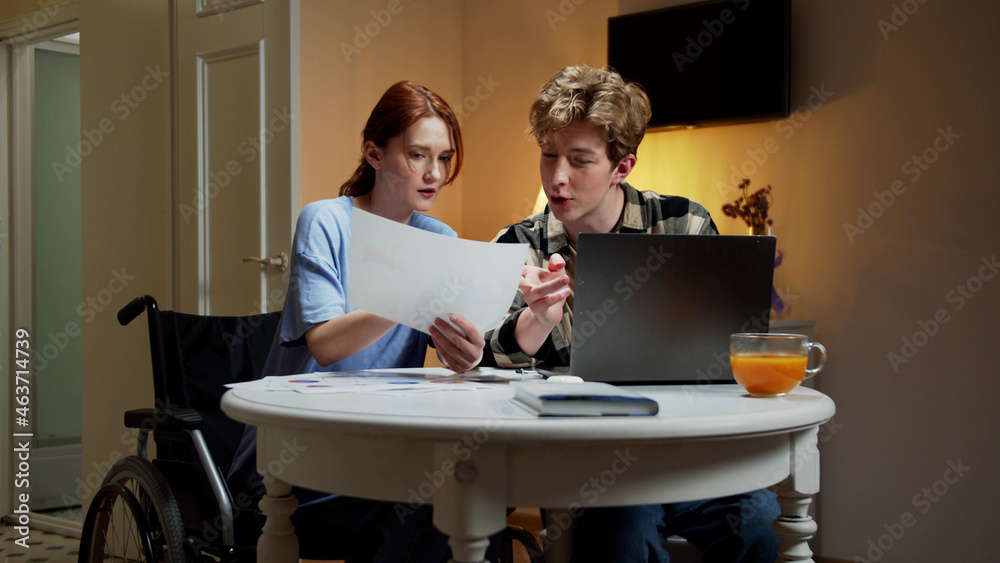 Obraz premium A disabled girl iand her friend are discussing about the project 