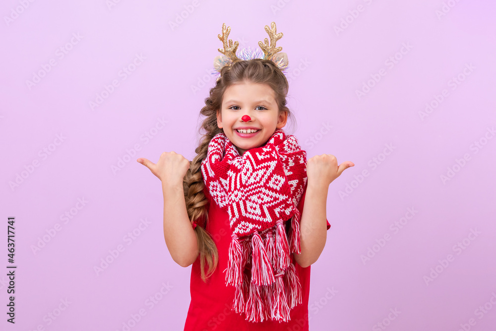A little girl with a New Year's deer mask is pointing her fingers in different directions.