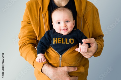 Crop father with cute baby in hoodie photo