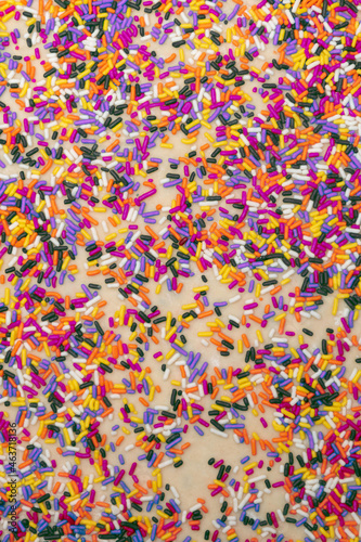 Colorful Halloween sprinkles on dough for baking treats background