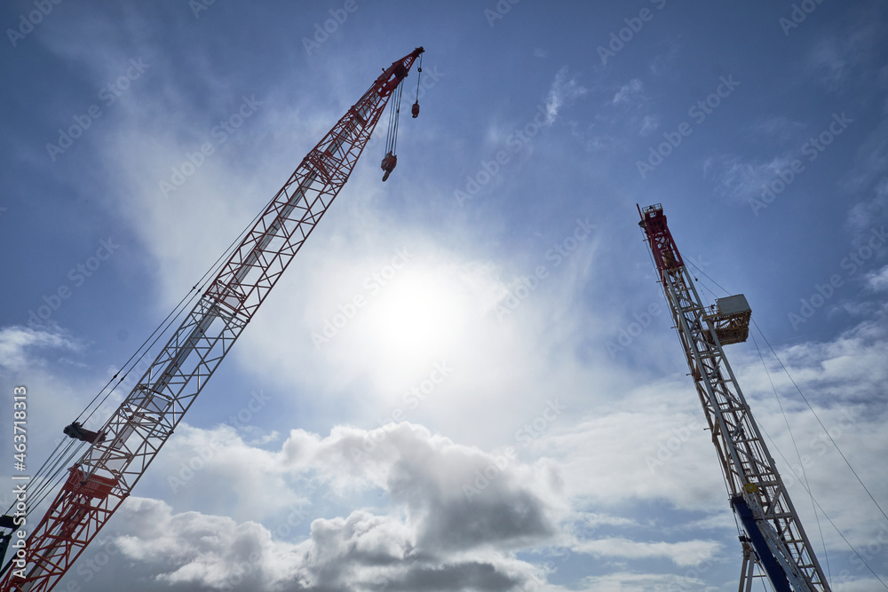 Large crane masts against a blue sky Large crane masts against a blue sky