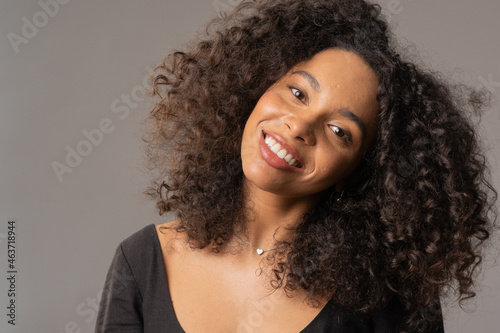 Portrait of smiling black woman on the gray background photo