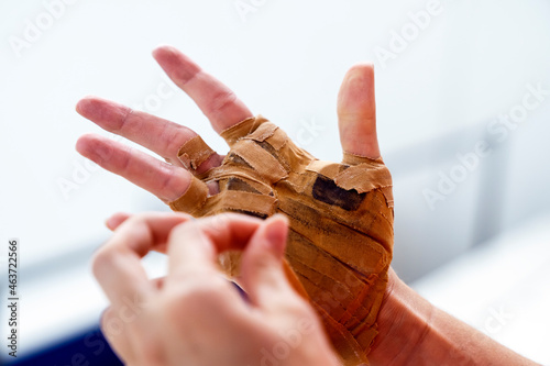 Close up view of hand of female player patched up to play traditional spanish game photo