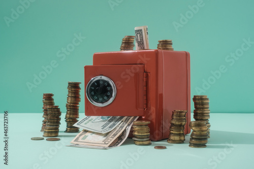 Dollar Bills And Coins With The Red Safe photo