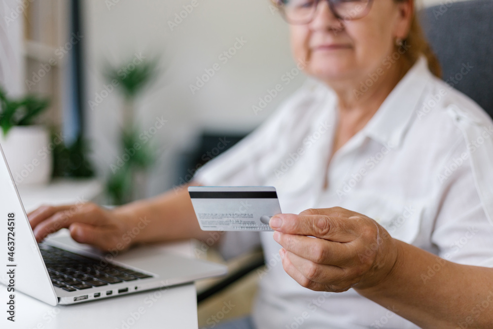 Senior woman using credit card for online payment Senior woman using credit card for online payment