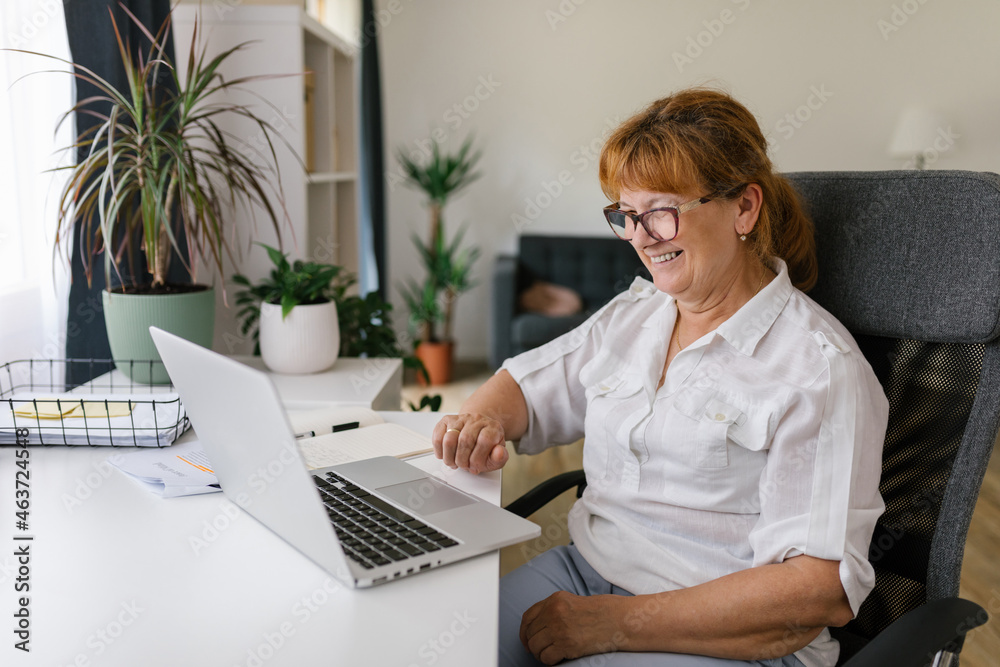 Happy senior woman using laptop at home Happy senior woman using laptop at home
