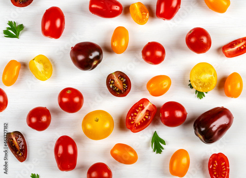 Colorful cherry tomatoes on wooden background, top view