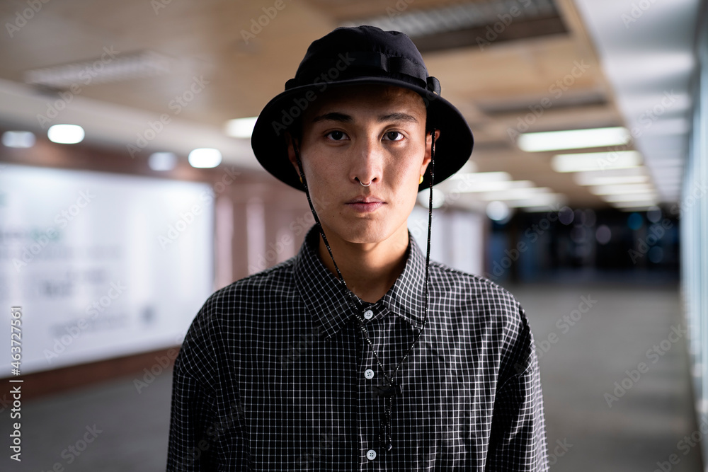 Portrait of a young man looking at camera in an indoor location