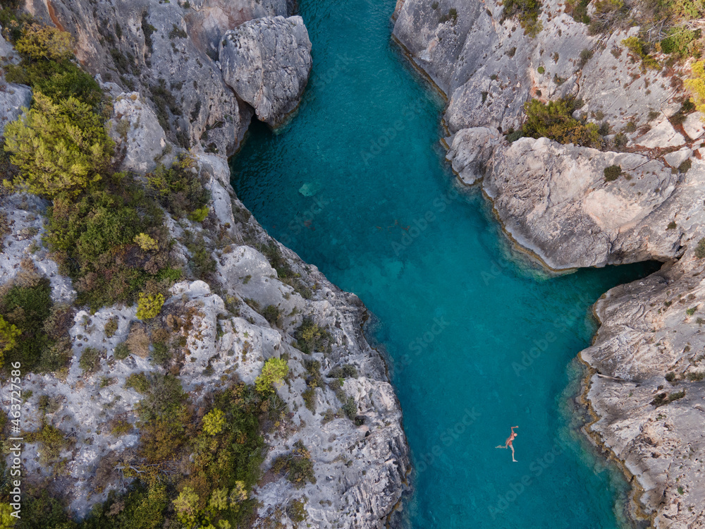 jumping from cliff, swimmer in crystal clear blue water jumping from cliff, swimmer in crystal clear blue water