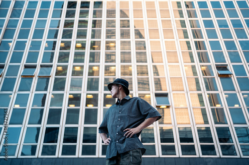 Young man standing and looking away in a urban scene