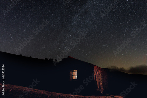 Mountain refuge under a starry sky photo