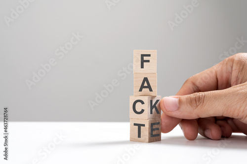 Obraz na plátně Hand flip wooden cube change the word from fake to fact