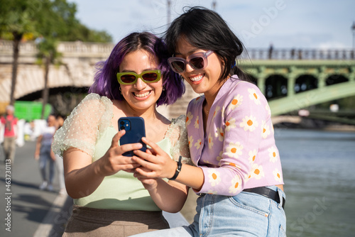 Friends Using Phone Outdoors