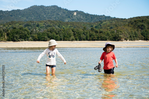 Kids crossing Awaroa Inlet, Abel Tasman National Park. photo